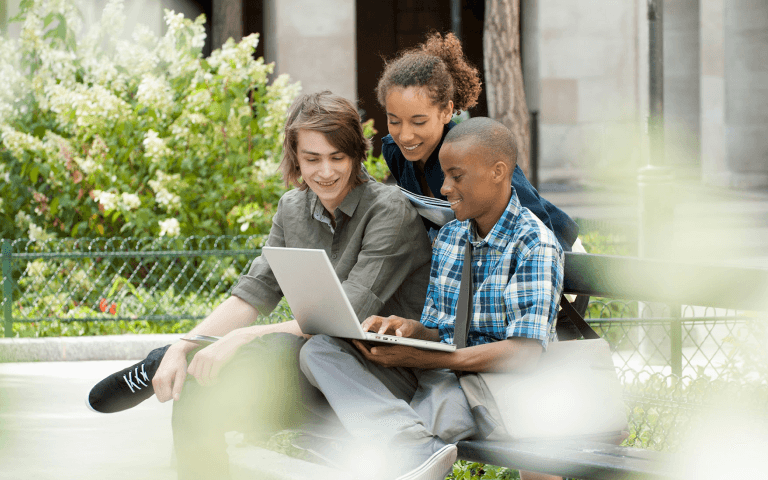 University students reviewing a laptop.